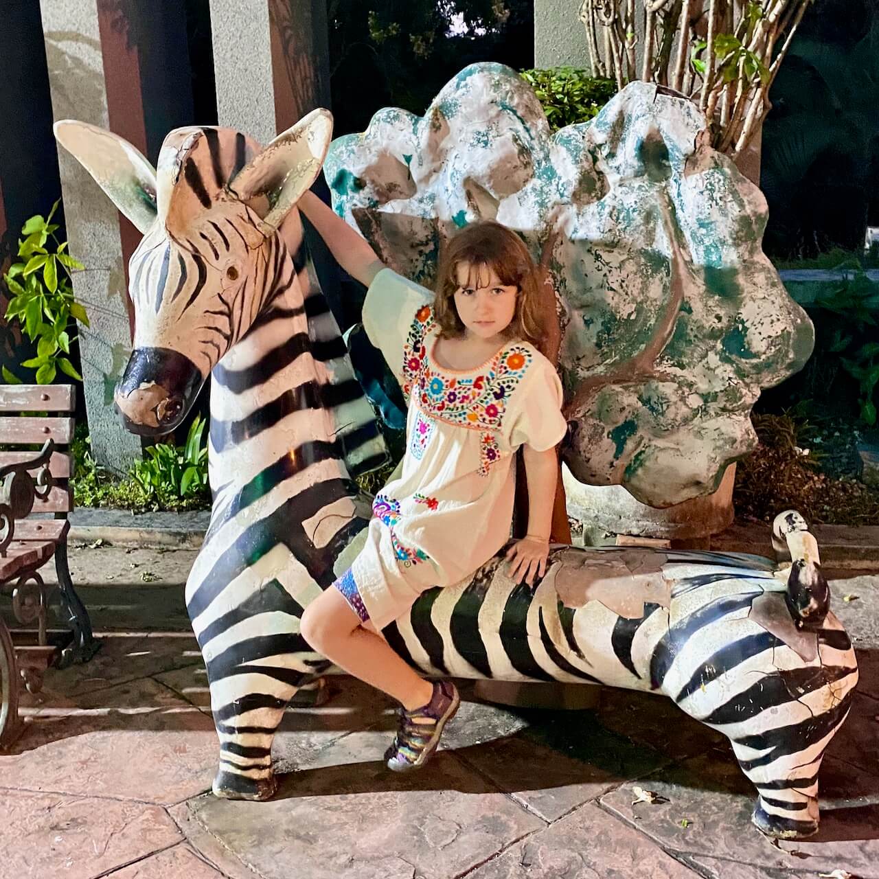 Birthday girl with her own zebra at Chiang Mai, Thailand's Night Safari.