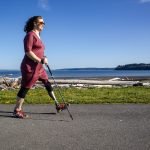 Amputee with prosthetic leg walks easily along a paved path on Whidbey Island.