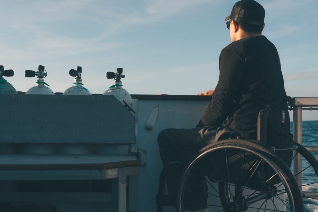Wheelchair user on a boat for adaptive diving training