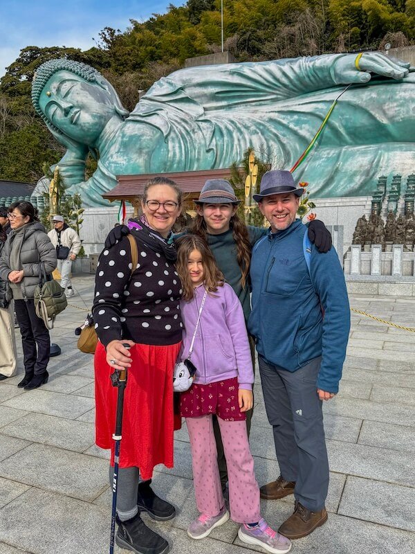 Nanzoin Buddha reclines behind a family visiting Japan