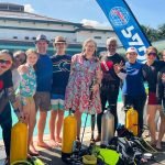 Adaptive dive trainers and scuba diving trainees, including amputee woman with prosthetic leg, in Kuala Lumpur, Malaysia