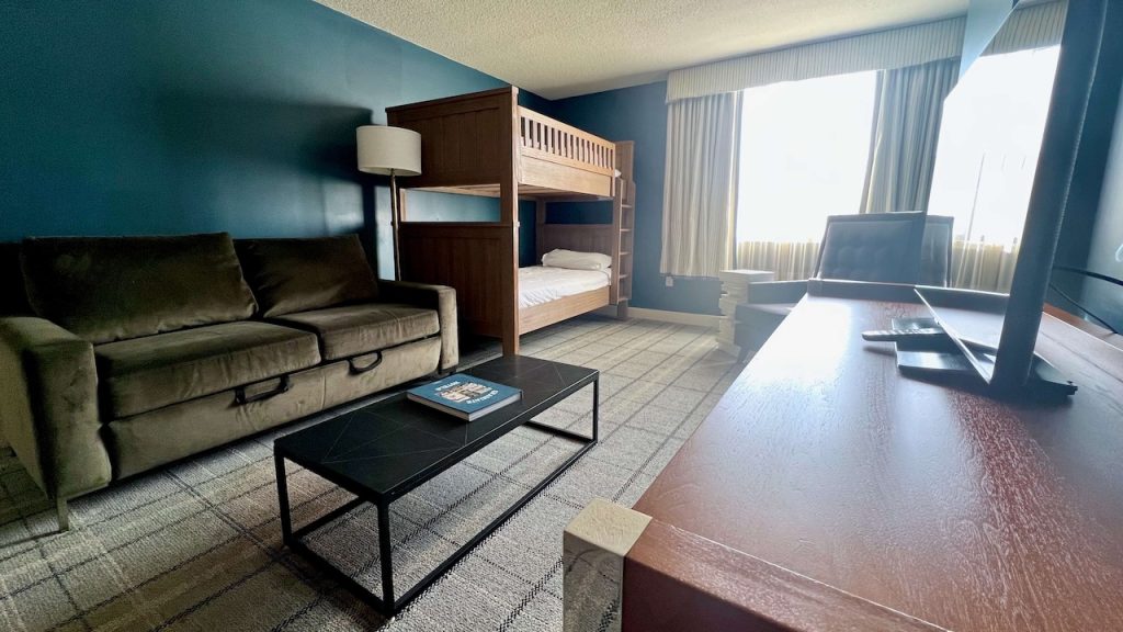 Bunk beds, couch, and living area in family room at Graduate Downtown Richmond