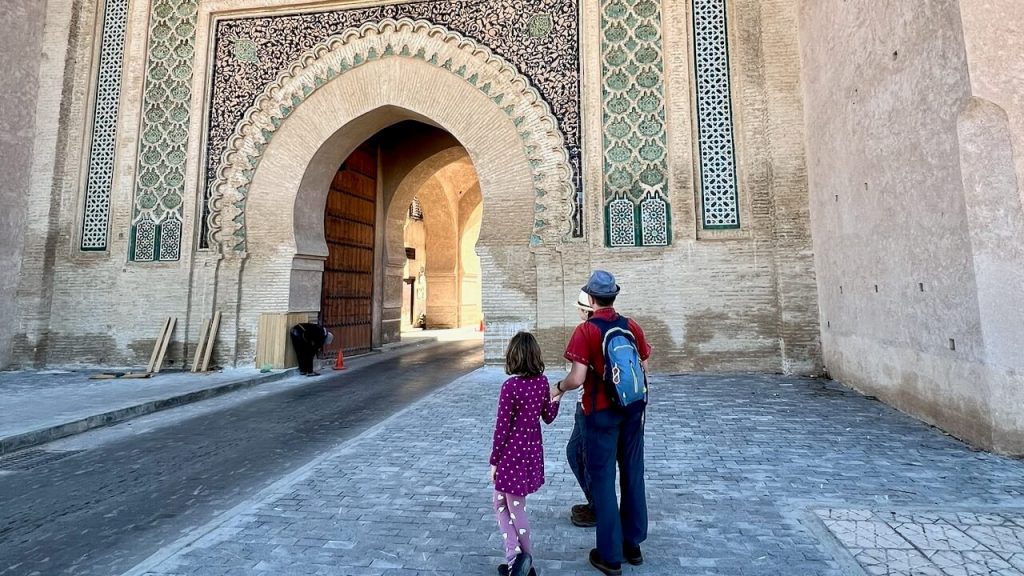 Daughter and dad stand before one of the medina gates in Meknes, Morocco. Our family of four has used eSIMs all over the world, from Malaysia to Morocco and beyond.